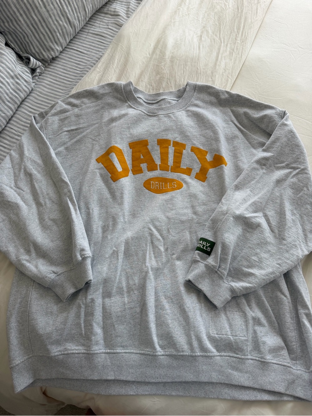 Daily Drills Light Gray Crewneck with Gold 'DAILY' Logo